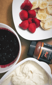 A photo of cream cheese filling, blueberry compote, hazelnut spread, sliced bananas and sliced strawberries