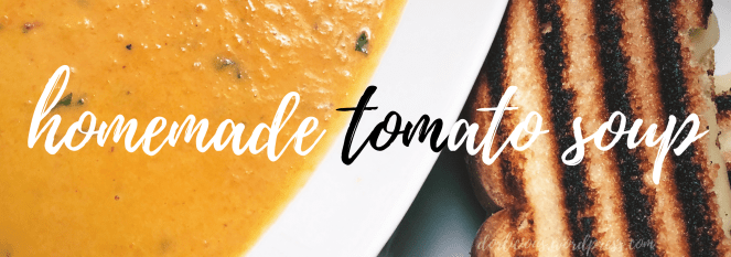 Tomato soup next to a grilled cheese with white and black overlay text that reads "homemade tomato soup"