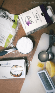 Heavy whipping cream, confectioners sugar, lemon, lemon juice in a tablespoon, lemon zest, a zester, and cream cheese.