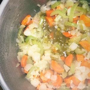 Pot of celery, carrots, onion and garlic with olive oil