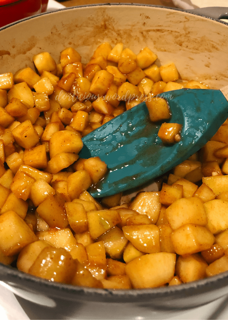 apples in a pot with a spoon